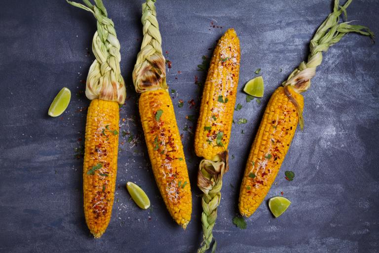 ears of grilled corn with lime, paprika, and cheese